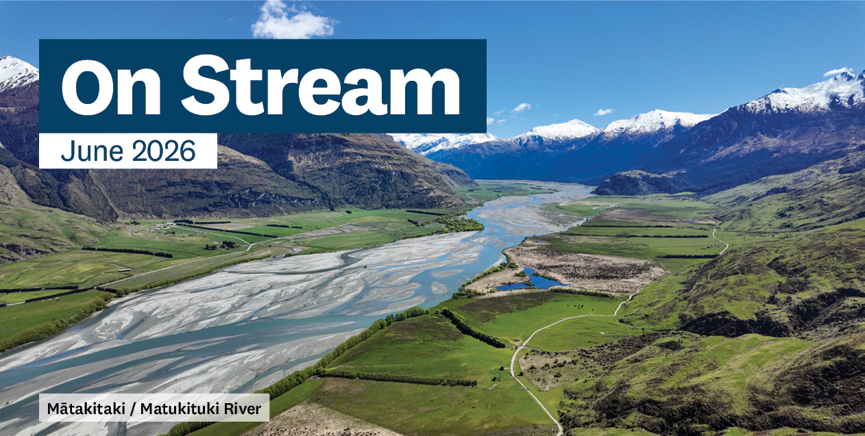 a view of a river running through a valley and mountains with the words 'On Stream' on it