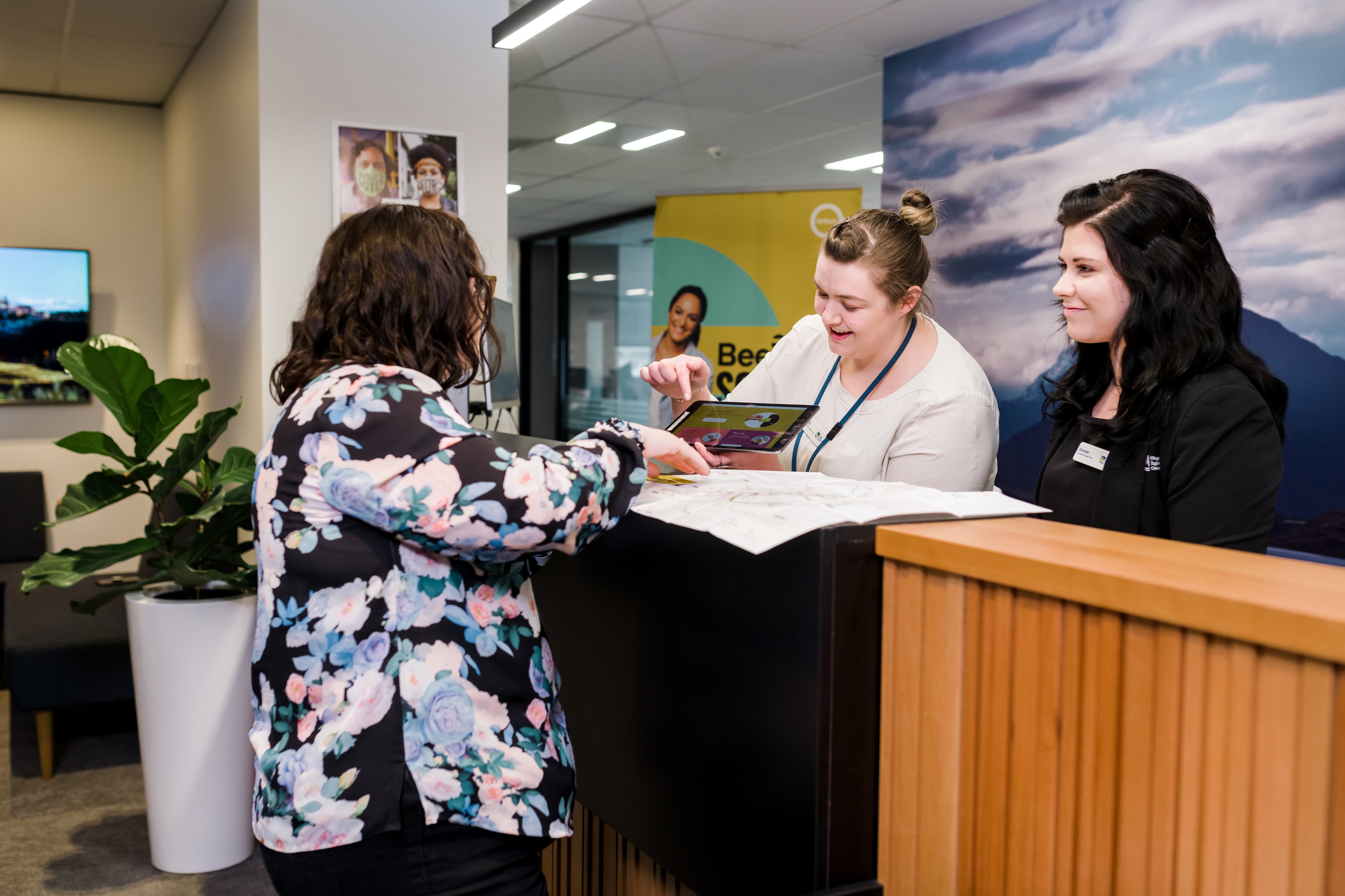 Image: Customer Experience staff at Level 2 Philip Laing House assisting with a public transport enquiry.