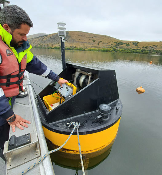 ORC Scientist Lakes, Hugo Borges, On Lake Hayes With A Limnotrack Buoy