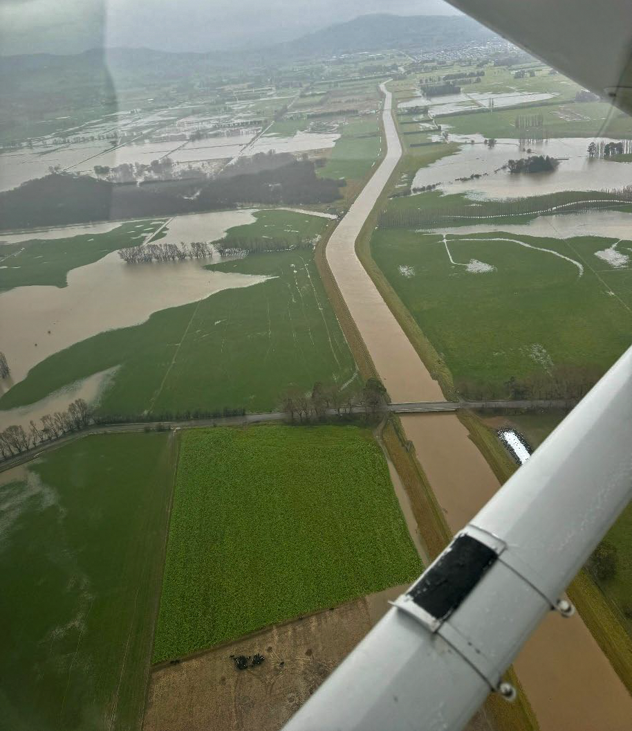 a view from the window of an airplane looking down at flooded fields