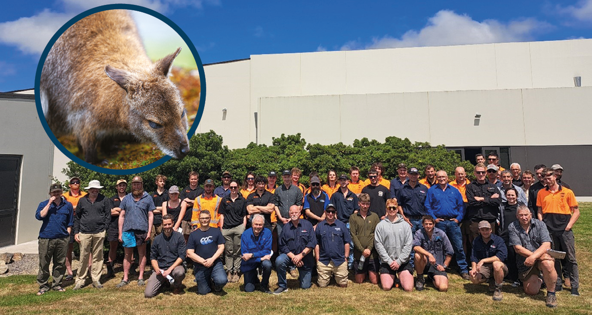 a group of people posing for a photo in front of a building with an inset of a wallaby
