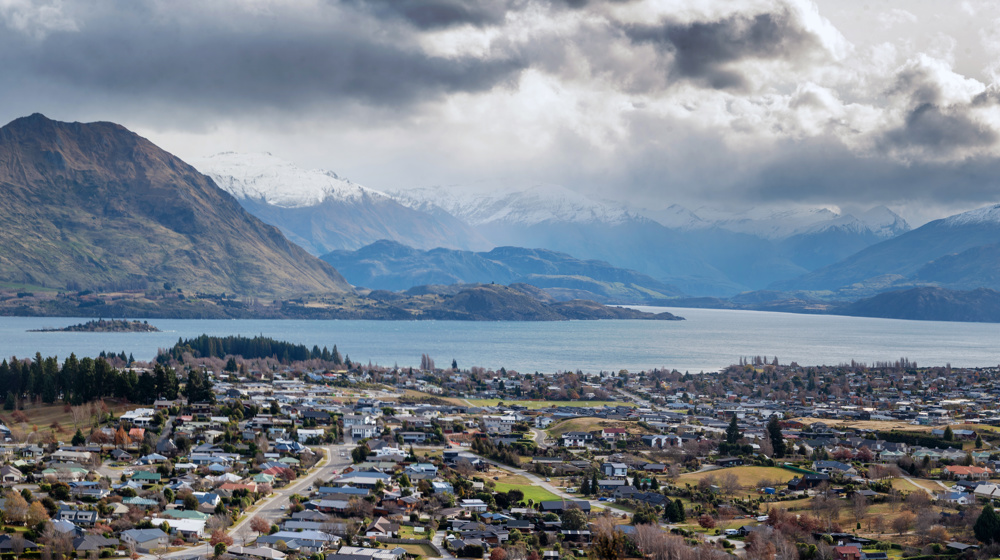 Elevated Panoramic View Of Wanaka, Otago, New Zealand With Lake Wanaka And Southern Alps In Background, As Seen From Mount Iron Peak Adobestock 1552909727