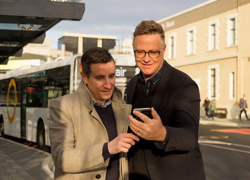 From left to right: Julian Phillips, ORC Public Transport Team Lead, and Shay Dewey, founder of My Little Local, check out the Orbus button on the My Little Local app at the Dunedin Bus Hub.