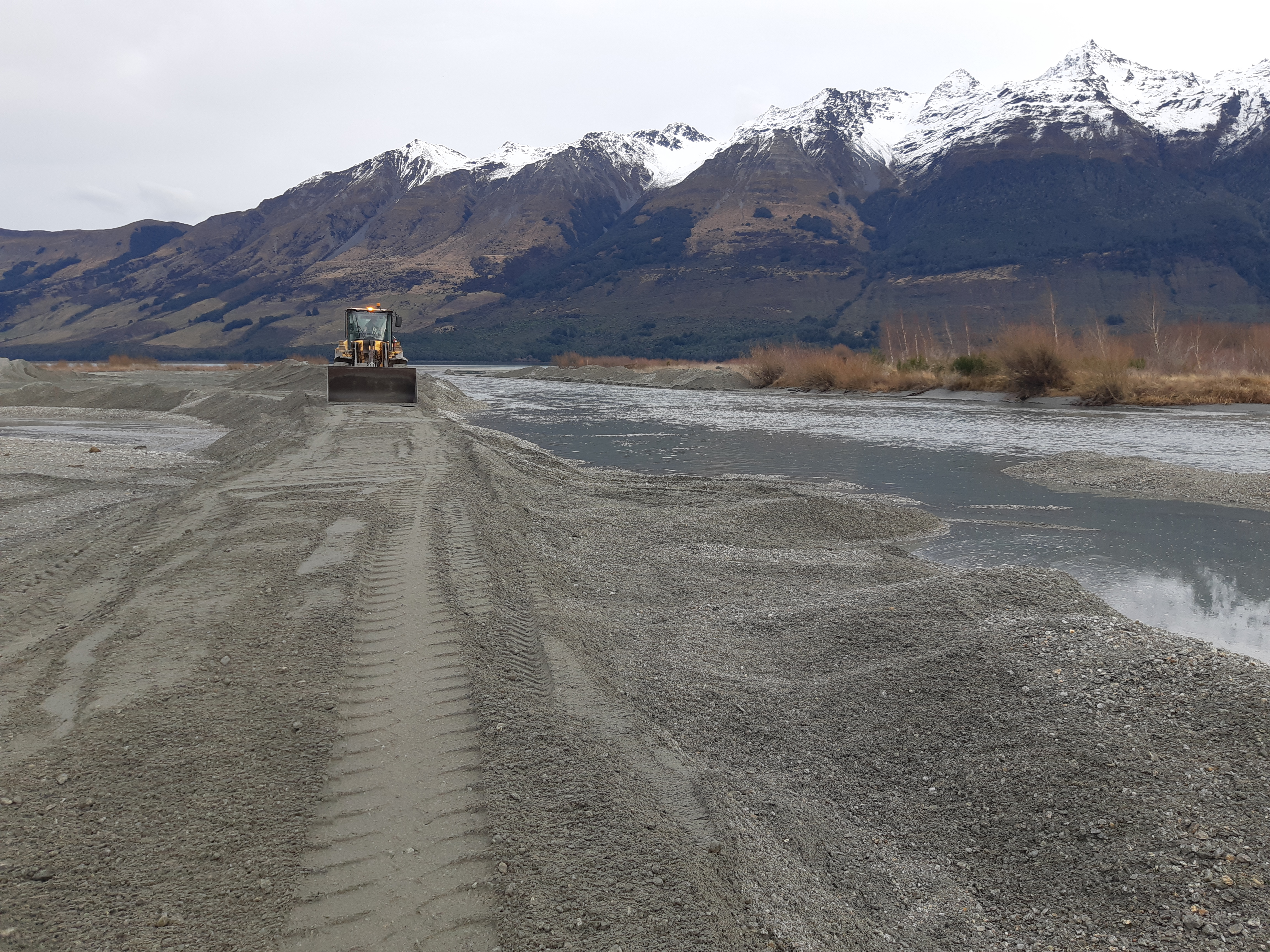 A loader on the Rees Delta works on aligning the Rees River channel towards the western side of the delta.