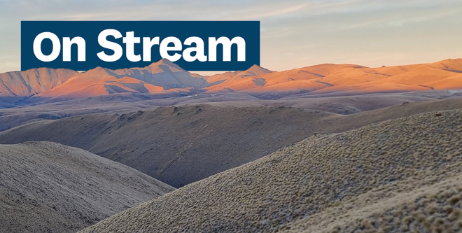 a view of hills and valleys with the words On Stream over the top