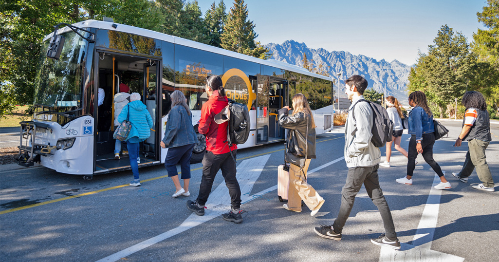 People boarding a bus in Queenstown How To Catch A Bus 1200 X 630