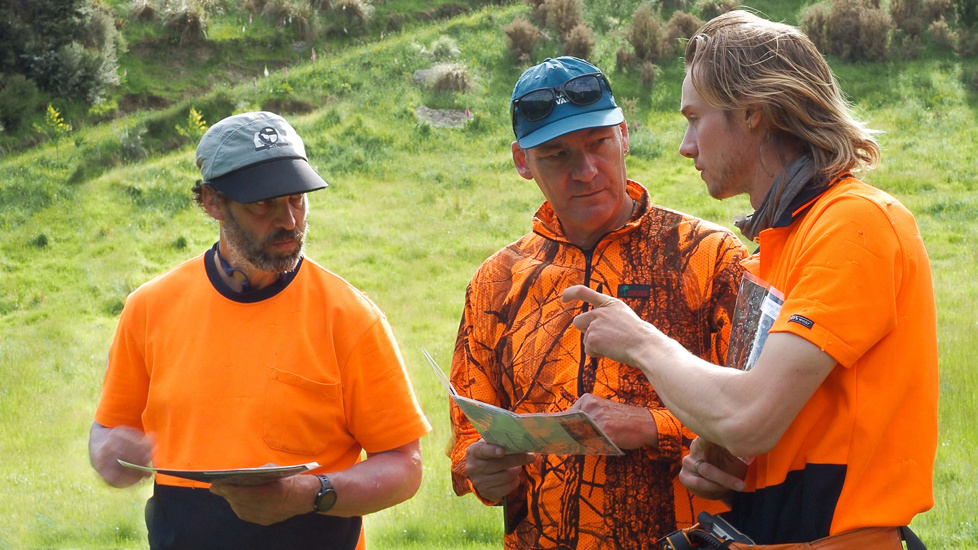 Thomas, Paul, And Jamie Looking Over The Site Map To Discuss The Day Two Workplan