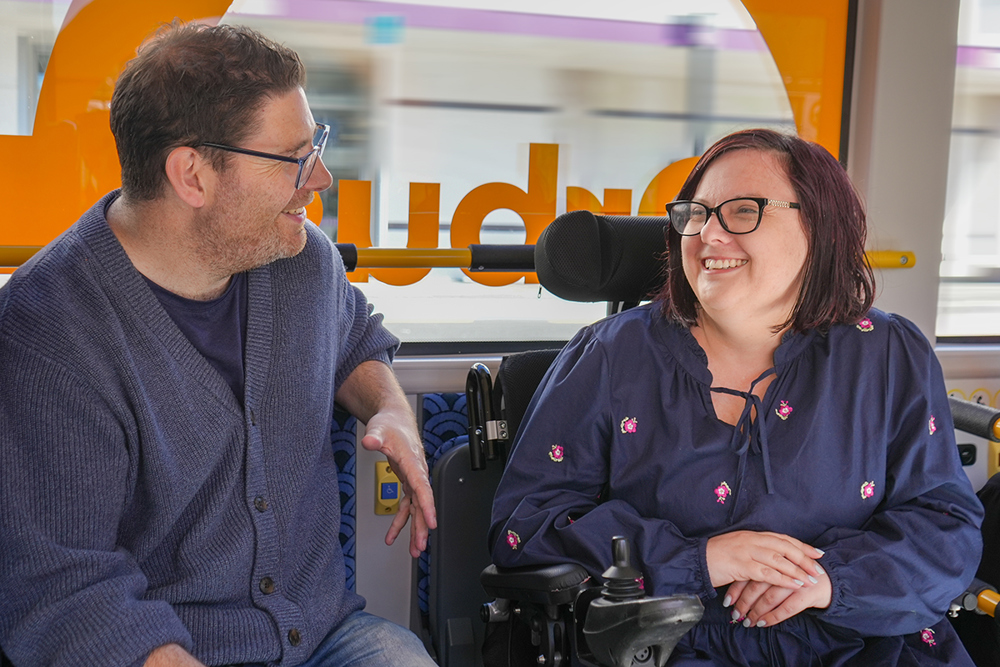 Amy And Tim Chatting On Orbus As Passengers On Bus