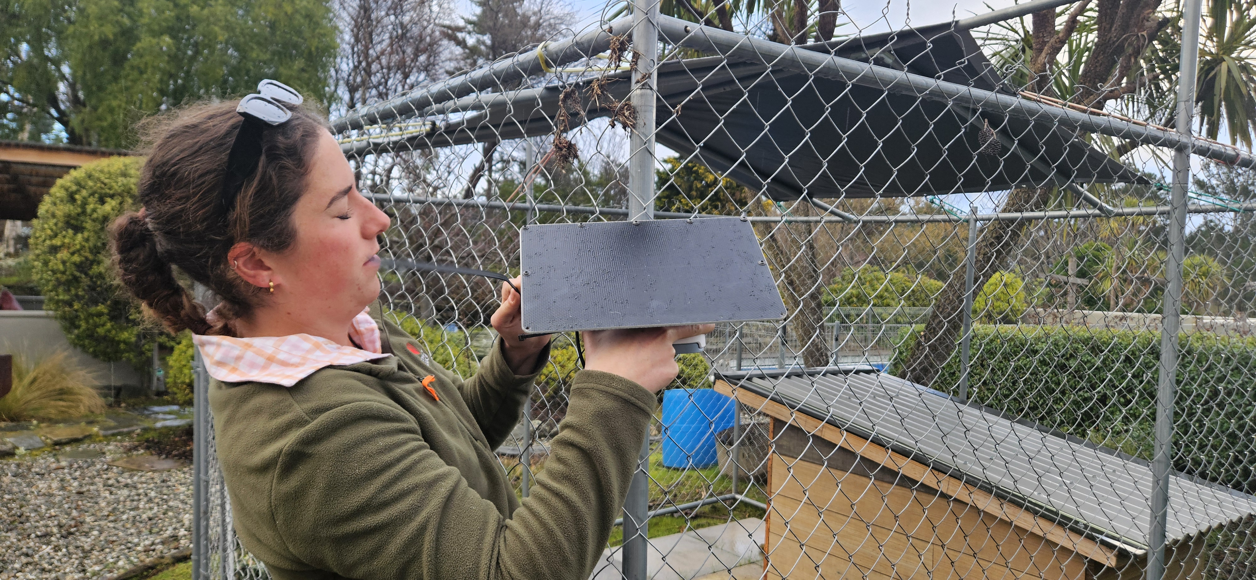 Local Project Volunteer, Ella Gordon, Installs An Outdoor Air Quality Monitor At A Participant's Home In Hawea