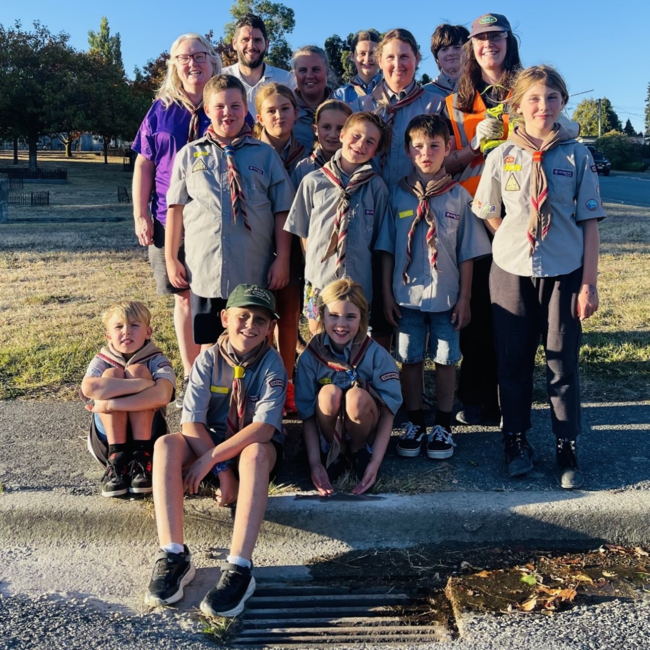 a group of children in scout uniform posing for a photo